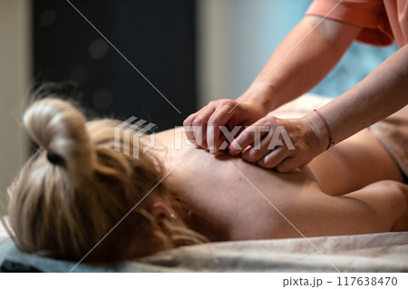 Back massage. Masseuse caring for clients. Massage for body health 117638470