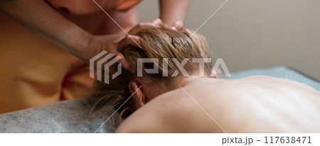Head massage. Masseuse, client and scalp care, headache treatment and physiotherapy for healing Head massage. Masseuse, client and scalp care, headache treatment and physiotherapy for healing 117638471