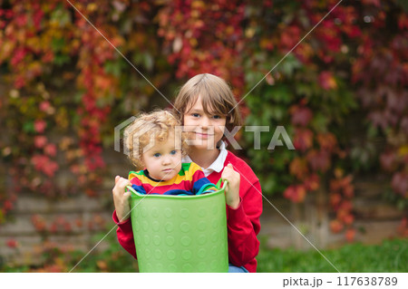 Child in fall park. Kid with autumn leaves. 117638789