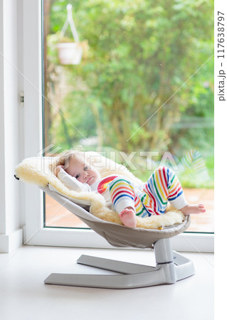 Toddler child in rocking chair Toddler child in rocking chair 117638797