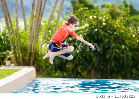 Kids jump into swimming pool. Summer water fun. 117638828