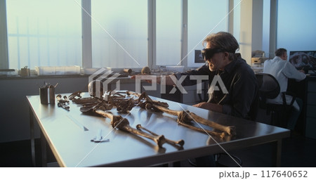 Mature archaeologist conducts historical research using virtual reality Mature archaeologist conducts historical research using virtual reality 117640652
