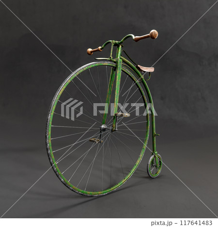 Retro Penny-farthing bicycle against black background 117641483