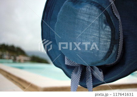 Young woman watching sunrise at a resort with a swimming pool overlooking the sea in Yeosu Young woman watching sunrise at a resort with a swimming pool overlooking the sea in Yeosu 117641631
