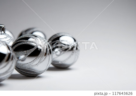 A row of shiny silver Christmas ornaments 117643626