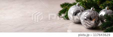 A white background with four silver Christmas ornaments on it A white background with four silver Christmas ornaments on it 117643629