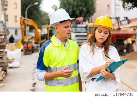 Master builder and architect talking in construction area Master builder and architect talking in construction area 117644736