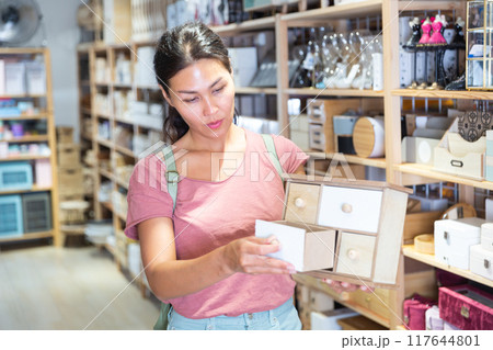 Woman choosing sundries storage box Woman choosing sundries storage box 117644801