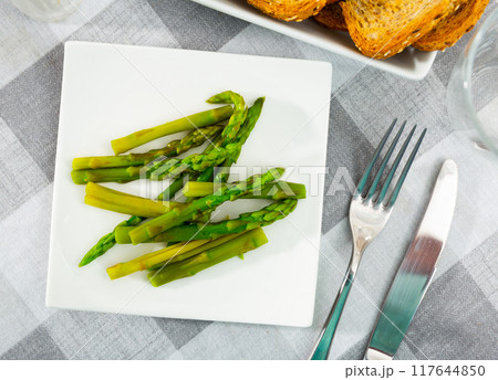 Boiled shoots of green asparagus are stacked in plate Boiled shoots of green asparagus are stacked in plate 117644850