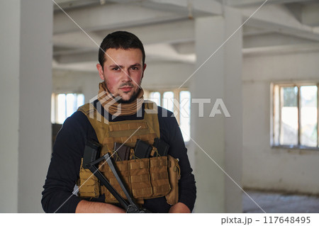 Modern warfare soldier portrait in urban environment 117648495