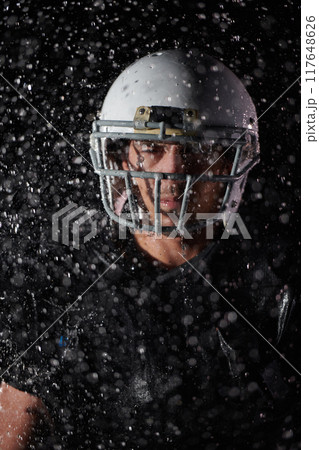 American Football Field: Lonely Athlete Warrior Standing on a Field Holds his Helmet and Ready to Play. Player Preparing to Run, Attack and Score Touchdown. Rainy Night with Dramatic Fog, Blue Light American Football Field: Lonely Athlete Warrior Standing on a Field Holds his Helmet and Ready to Play. Player Preparing to Run, Attack and Score Touchdown. Rainy Night with Dramatic Fog, Blue Light 117648626
