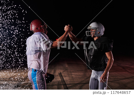 Two american football players face to face in silhouette shadow on white background Two american football players face to face in silhouette shadow on white background 117648657