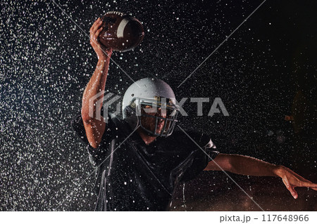 American Football Field: Lonely Athlete Warrior Standing on a Field Holds his Helmet and Ready to Play. Player Preparing to Run, Attack and Score Touchdown. Rainy Night with Dramatic Fog, Blue Light American Football Field: Lonely Athlete Warrior Standing on a Field Holds his Helmet and Ready to Play. Player Preparing to Run, Attack and Score Touchdown. Rainy Night with Dramatic Fog, Blue Light 117648966