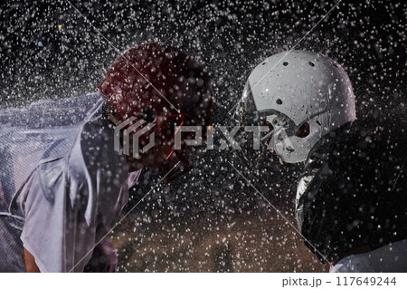 Two american football players face to face in silhouette shadow on white background 117649244