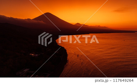 Panoramic view of coastline with volcano and sunset with quiet ocean in Bali. 117649264