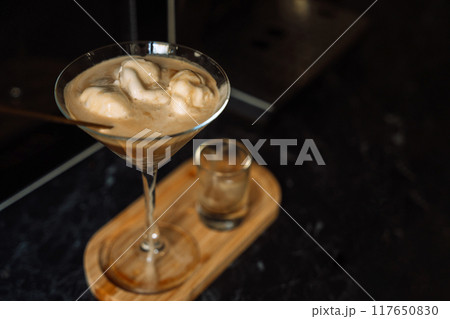 Homemade dessert ice cream with coffee in a glass on a wooden tray 117650830