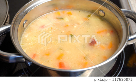 Pea Soup Cooking in Pot on Stove Pea Soup Cooking in Pot on Stove 117650873