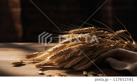 Table made of wooden planks with ears of wheat. Copy space for presentation of rustic business product 117652591