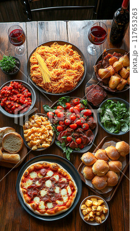 A top-down view of a full table spread with a variety of classic Italian dishes A top-down view of a full table spread with a variety of classic Italian dishes 117653263