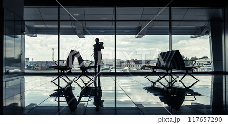 silhouette of a girl in an airport terminal 117657290