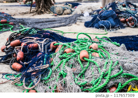 pile of fishing nets with floats and colorful ropes 117657309