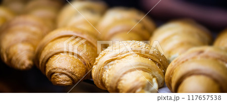 Tasty croissants sprinkled with sesame Tasty croissants sprinkled with sesame 117657538