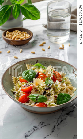 Experience a modern gourmet presentation of Caprese Farfalle Salad, elegantly combining Farfalle pasta with juicy cherry tomatoes, fresh mozzarella balls, and aromatic basil pesto Experience a modern gourmet presentation of Caprese Farfalle Salad, elegantly combining Farfalle pasta with juicy cherry tomatoes, fresh mozzarella balls, and aromatic basil pesto 117657606