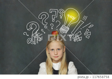 Adorable child girl student with yellow light bulb and question marks Adorable child girl student with yellow light bulb and question marks 117658758