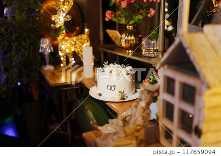 White wedding cake decorated with chocolate flowers and blueberries  117659094
