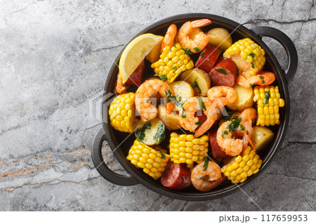 Homemade Cajun Seafood Boil with shrimp, corn, baby potatoes, sausage and lemons closeup. Horizontal top view 117659953