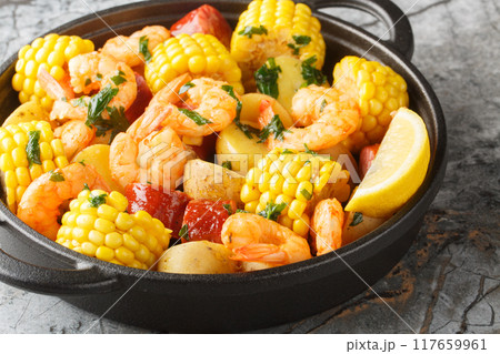 Homemade Cajun Seafood Boil with shrimp, corn, baby potatoes, sausage and lemons closeup. Horizontal 117659961
