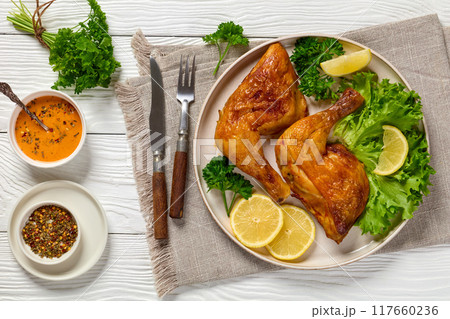 fried chicken legs with lettuce, lemon on plate fried chicken legs with lettuce, lemon on plate 117660236