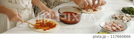 Family Cooking Pizza Together In The Kitchen Family Cooking Pizza Together In The Kitchen 117660666