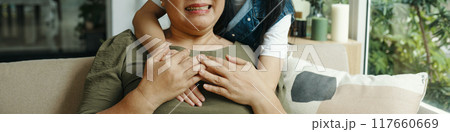 Granddaughter Embracing Her Grandma At Home Granddaughter Embracing Her Grandma At Home 117660669