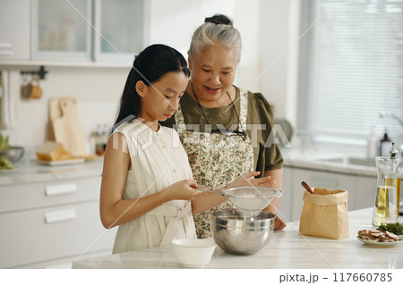 Girl Learning To Bake Cake With Grandma Girl Learning To Bake Cake With Grandma 117660785