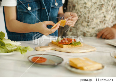 Girl Making Sandwich For Breakfast Girl Making Sandwich For Breakfast 117660824