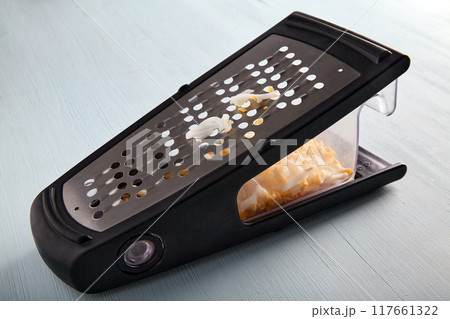 Chopped boiled chicken egg grated on a metal grater 117661322