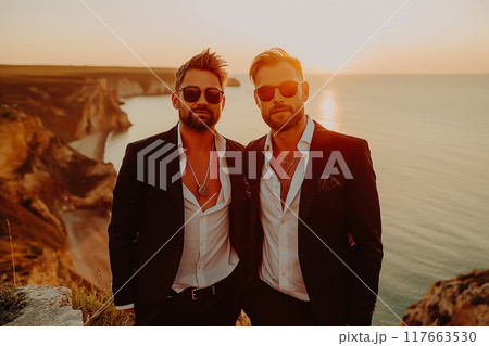 Two bearded men, a gay couple, hold hands. Two bearded men, a gay couple, hold hands. 117663530