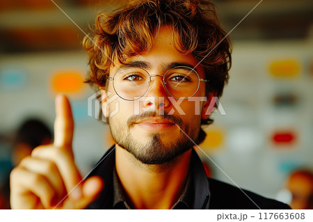 Businessman pointing upwards with confident little smile. focus on finger 117663608