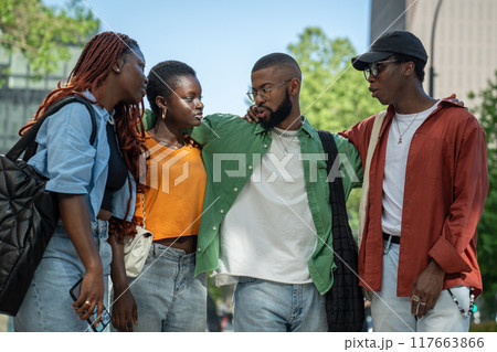 Four stylish african american best friends strolling around town with interest chats relaxed feeling Four stylish african american best friends strolling around town with interest chats relaxed feeling 117663866