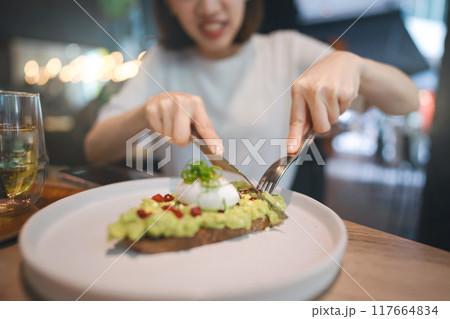 Guacamole avocado healthy food and asian woman background at indoor restaurant on day 117664834