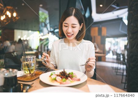 Asian woman eating healthy food at cafe restaurant city break on weekend lifestyle 117664840