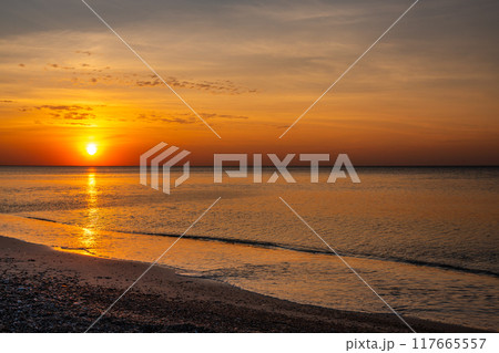 Sandy beach with pebbles of Baltic Sea on Curonian Spit at sunset. Kaliningrad region. Russia Sandy beach with pebbles of Baltic Sea on Curonian Spit at sunset. Kaliningrad region. Russia 117665557