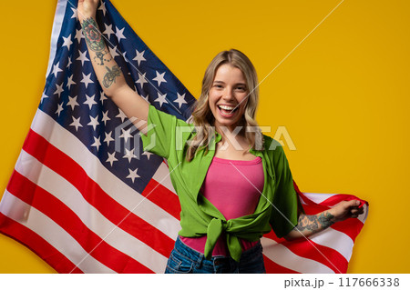 Proud Smiling Adult Woman With National Usa Flag On Yellow Background Proud Smiling Adult Woman With National Usa Flag On Yellow Background 117666338