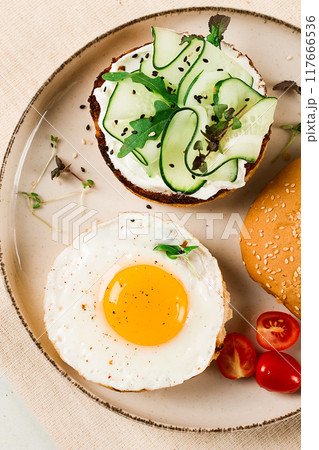 Assortment of sandwiches, white bread, fried egg, cream cheese and cucumber, capelin caviar, sesame bun, breakfast, on a white table, no people, 117666536