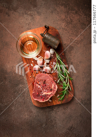 fresh, raw rib eye steak, on a chopping board, top view, no people, 117666777