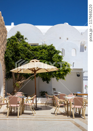 Patio of a hotel with chairs and sun umbrella, Djerba, Tunisia Patio of a hotel with chairs and sun umbrella, Djerba, Tunisia 117668220