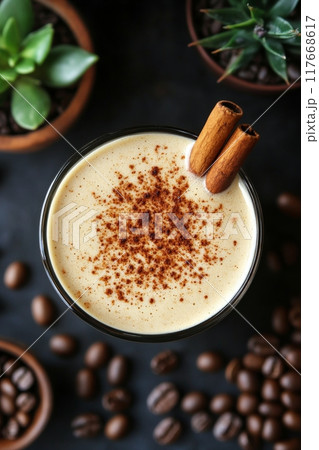 Iced coffee drinks with cinnamon garnish and coffee beans on a dark background Iced coffee drinks with cinnamon garnish and coffee beans on a dark background 117668617