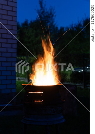 The fire is burning in the grill. A bonfire burning at night The fire is burning in the grill. A bonfire burning at night 117669029