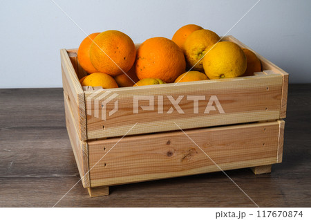 Fresh orange fruits box,High angle view of oranges in container on table Fresh orange fruits box,High angle view of oranges in container on table 117670874
